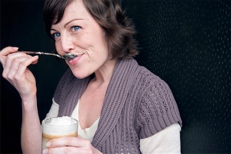 Woman Eating Cream from Latte Foto de stock - Con derechos protegidos, Código: 700-00948634