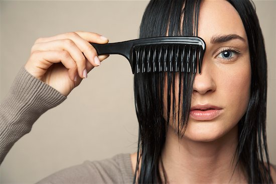 Woman Combing Hair Stock Photo - Premium Rights-Managed, Artist: Masterfile, Image code: 700-00954597