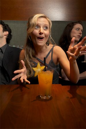 Woman Talking in Bar With Bored Friends Stock Photo - Rights-Managed, Code: 700-00955192