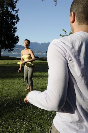 play frisbee in the beach - Couple Playing Frisbee Stock Photo - Rights-Managed, Code: 700-00955236