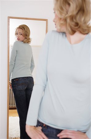 Woman Looking in Mirror Stock Photo - Rights-Managed, Code: 700-00984306