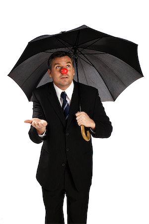 simsearch:700-01494664,k - Businessman with Clown Nose and Umbrella Foto de stock - Con derechos protegidos, Código: 700-01015009