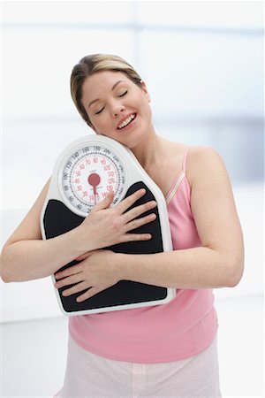 scales weight woman happy - Woman Hugging Scale Stock Photo - Rights-Managed, Code: 700-01015080