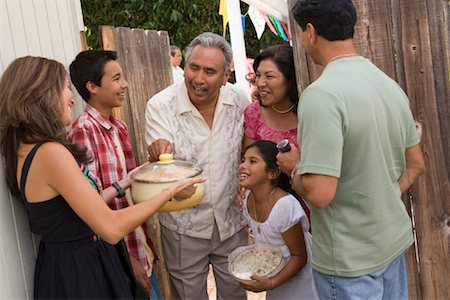 senior man outside hispanic candid - Family being Greeted at Family Gathering Stock Photo - Rights-Managed, Code: 700-01041264