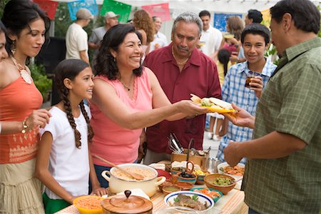 senior man outside hispanic candid - Woman Serving Food at Family Gathering Stock Photo - Rights-Managed, Code: 700-01041317