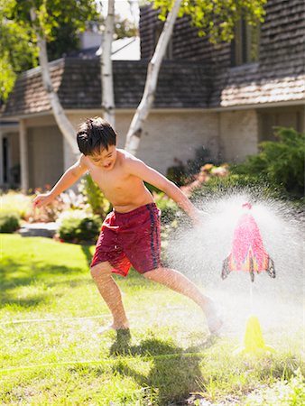 Boy Playing in Sprinkler Stock Photo - Rights-Managed, Code: 700-01041381