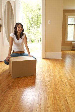 photos of asian people moving houses - Woman Holding Box in Home Stock Photo - Rights-Managed, Code: 700-01043078