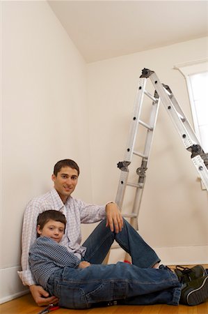 portrait of family lying down side by side - Father and Son Sitting by Ladder Stock Photo - Rights-Managed, Code: 700-01043079