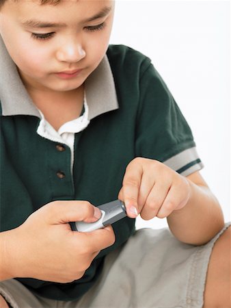 Boy Using Glucose Meter Foto de stock - Con derechos protegidos, Código: 700-01043510