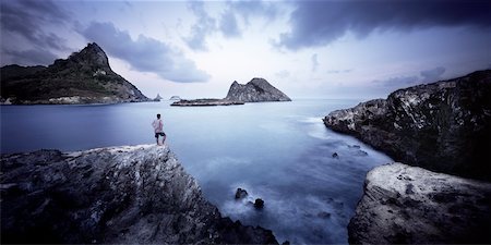 Man on Cliff Looking at the Ocean, Fernando de Noronha, Brazil Stock Photo - Rights-Managed, Code: 700-01084054