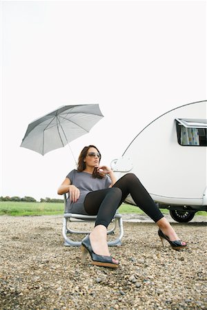 Woman Sitting on Lawn Chair by Trailer Stock Photo - Rights-Managed, Code: 700-01082879