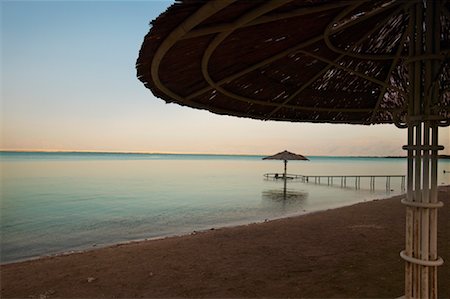 Tiki Umbrellas on Beach at, Sunset, Dead Sea, Israel Stock Photo - Rights-Managed, Code: 700-01109754