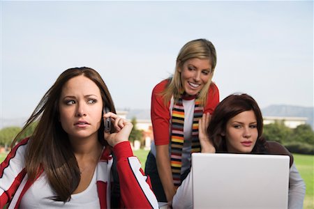 student group outside with laptop - Friends Outdoors Using Cellular Phone and Laptop Foto de stock - Con derechos protegidos, Código: 700-01109889