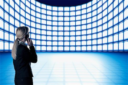 stack of phones - Business Woman Looking at Video Wall Stock Photo - Rights-Managed, Code: 700-01109919