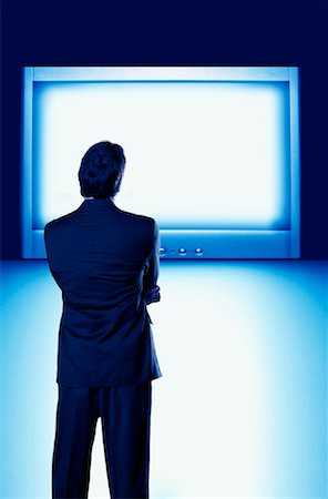 Businessman Standing in Front of Glowing Monitor Stock Photo - Rights-Managed, Code: 700-01109930