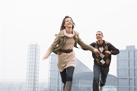 smiling laughing portrait city - Couple Running Stock Photo - Rights-Managed, Code: 700-01100323