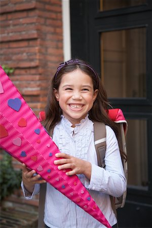 Girl Standing in Front of School Holding Wrapped Gift Stock Photo - Rights-Managed, Code: 700-01119760