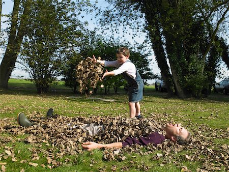 Girl Playing in Leaves With Father Stock Photo - Rights-Managed, Code: 700-01119825
