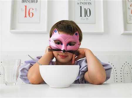 Masked Girl Eating Breakfast Stock Photo - Rights-Managed, Code: 700-01119883