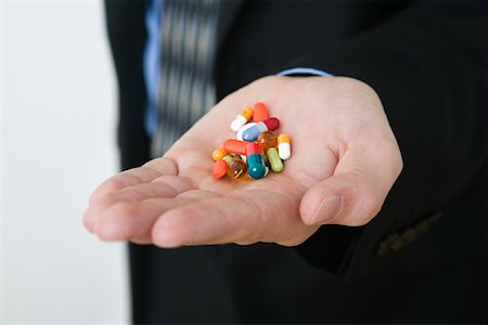 Businessman with Handful of Pills Foto de stock - Con derechos protegidos, Código: 700-01110588