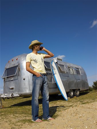 surfboard mobile - Man in Front of Camper, Using Cell Phone Stock Photo - Rights-Managed, Code: 700-01111446