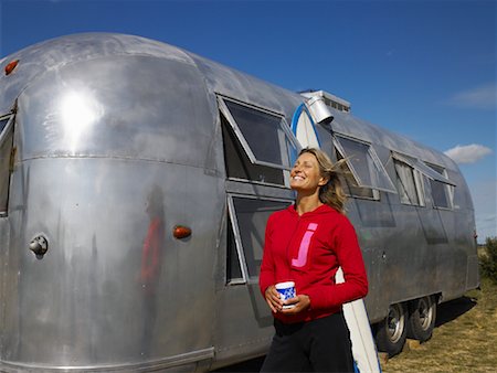 drinking outside caravan - Woman Holding Cup of Coffee, Beside Camper Stock Photo - Rights-Managed, Code: 700-01111447