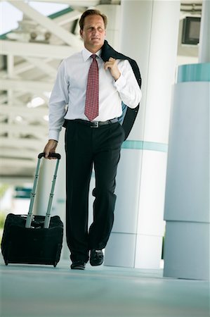 Businessman Walking with Luggage Stock Photo - Rights-Managed, Code: 700-01112438