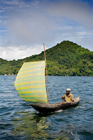 sail (fabric for transmitting wind) - Man in Dugout Sailboat, Nosy Mangabe Island, Maroantsetra, Madagascar Stock Photo - Rights-Managed, Code: 700-01112705