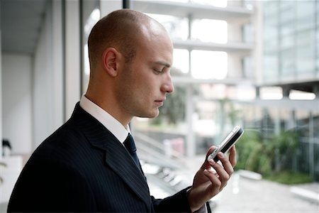 simsearch:700-01164516,k - Businessman Looking at Cell Phone Foto de stock - Direito Controlado, Número: 700-01164520