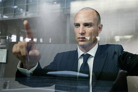 Businessman Pressing Finger Against Window Stock Photo - Rights-Managed, Code: 700-01164542