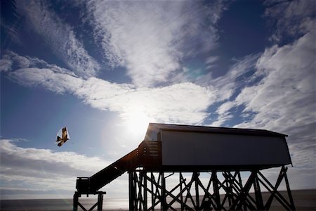 Kite Flying by Raised Building on Beach, St Peter Ording, Schleswig-Holstein, Germany Stock Photo - Rights-Managed, Code: 700-01164788