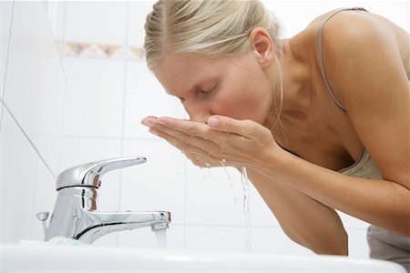 person bending over cleaning - Woman Rinsing After Brushing Teeth Stock Photo - Rights-Managed, Code: 700-01165021