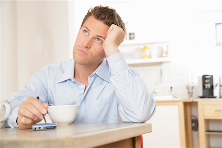 Man Using Electronic Organizer at Breakfast Stock Photo - Rights-Managed, Code: 700-01165139