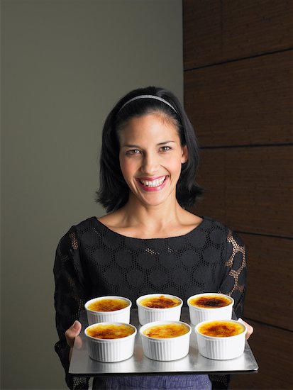Woman Holding Creme Brulee Servings Stock Photo - Premium Rights-Managed, Artist: Masterfile, Image code: 700-01174098