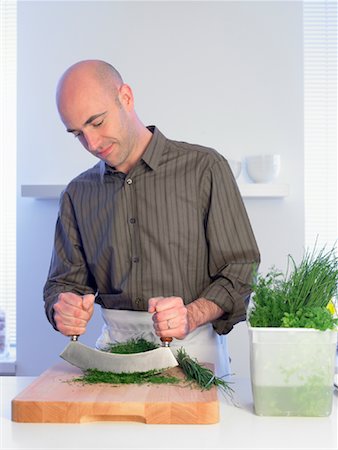 Man Chopping Wheatgrass Stock Photo - Rights-Managed, Code: 700-01174115