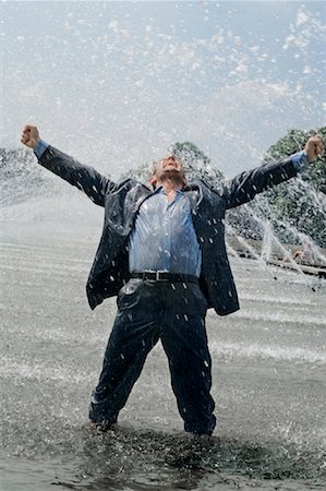 Excited Businessman Splashing in Water Fountain Stock Photo - Rights-Managed, Code: 700-01172963