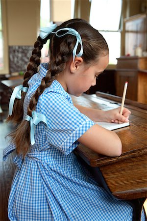 ribbon and pigtails - Girl Writing in Classroom Stock Photo - Rights-Managed, Code: 700-01173193