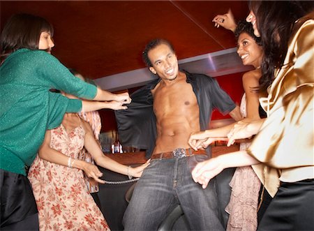 Women Pulling on Man's Shirt on Dance Floor Foto de stock - Con derechos protegidos, Código: 700-01173368