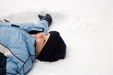 snow angel - Boy Lying in Snow Stock Photo - Rights-Managed, Code: 700-01173389