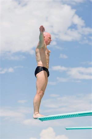 profile of person diving into pool - Man on Diving Board Stock Photo - Rights-Managed, Code: 700-01184383