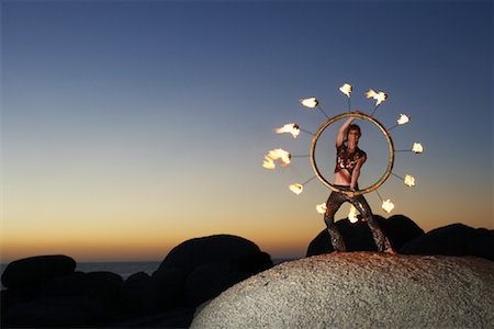 simsearch:700-01185206,k - Circus Performer Holding Burning Fire Wheel Stock Photo - Rights-Managed, Code: 700-01185177