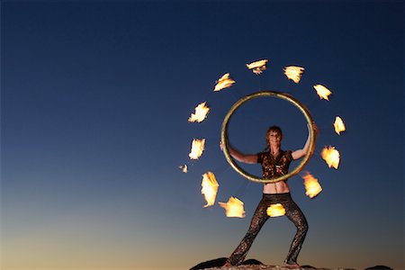 dangerous balancing acts - Circus Performer Holding Burning Fire Wheel Stock Photo - Rights-Managed, Code: 700-01185178