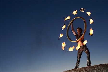 simsearch:700-01185177,k - Circus Performer Holding Burning Fire Wheel Stock Photo - Rights-Managed, Code: 700-01185179