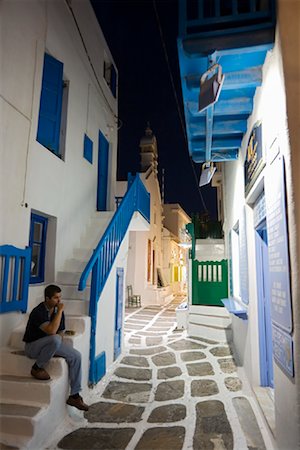 Man Sitting on Steps, Mykonos Town, Mykonos, Greece Stock Photo - Rights-Managed, Code: 700-01185436