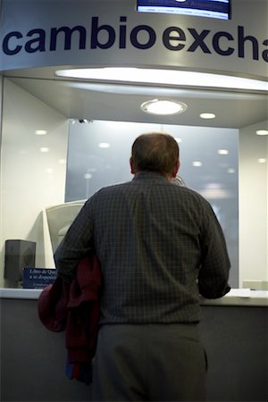 Man at Money Exchange Counter in Airport Stock Photo - Rights-Managed, Code: 700-01182766