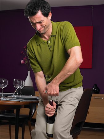 person opening shirt - Man Opening Wine Bottle Stock Photo - Rights-Managed, Code: 700-01183862