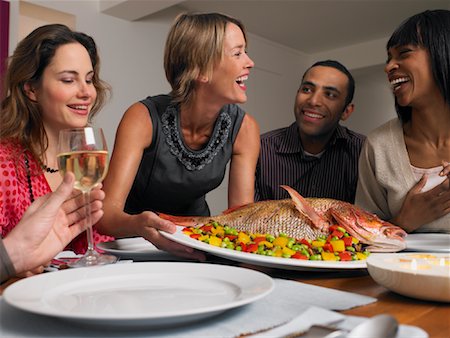 european woman holding fish - People at Dinner Party Stock Photo - Rights-Managed, Code: 700-01183913