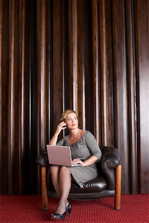 Woman in Foyer with Laptop Computer and Cellular Phone Stock Photo - Rights-Managed, Code: 700-01194338