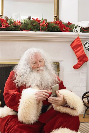 simsearch:400-03919056,k - Père Noël à l'aide d'agenda électronique Photographie de stock - Rights-Managed, Code: 700-01195283