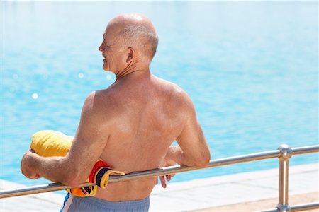 person leaning on rail with back - Man at Swimming Pool Stock Photo - Rights-Managed, Code: 700-01199295